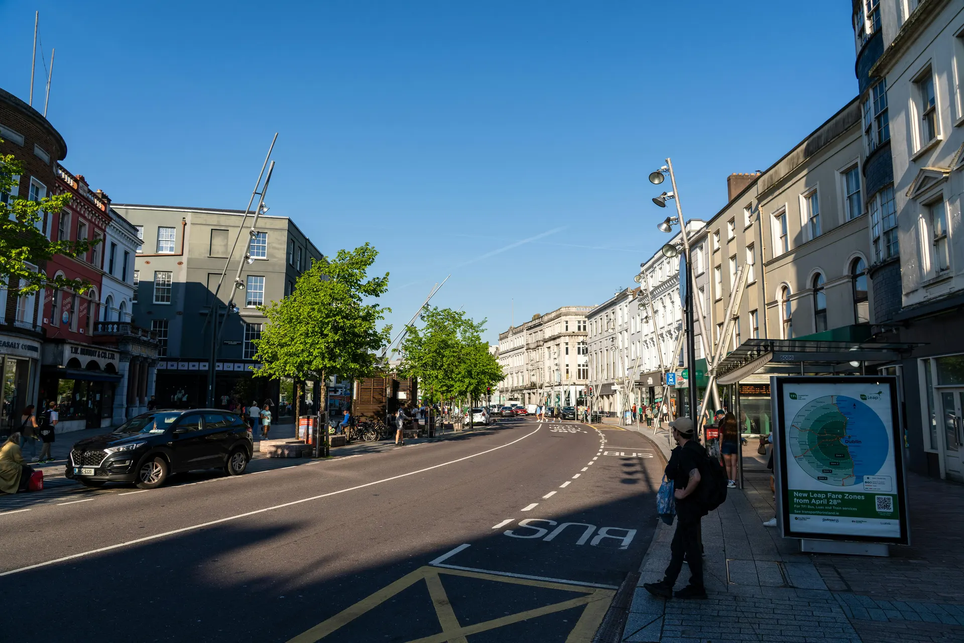 Busy Irish market street with warm awnings and editorial street colour